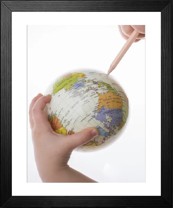 Framed Print : Child holding a globe and pen print on white background Framed Print : Child holding a globe and pen print on white background
