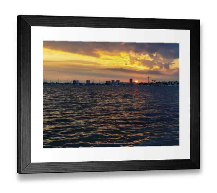 Framed Print : The sun sets over a calm coastal bay Framed Print : The sun sets over a calm coastal bay