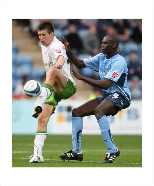 Battle for the Ball: Rasiak vs. Grandison in the Intense Championship Clash between Coventry City and Reading