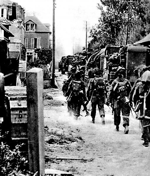 Allied Troops moving through a French village; Second World