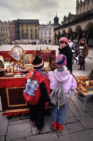 Boy and girl look at souvenir stall, Main Square, Krakow
