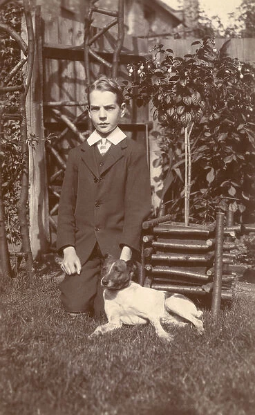 Boy with a Jack Russell terrier in a garden