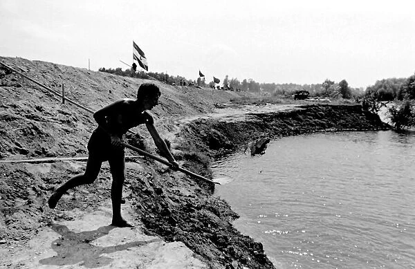 Boy with a spade, taking part in a Communist Youth labour camp in former Yugoslavia