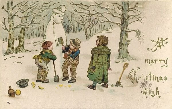 Boys building a snowman in the woods