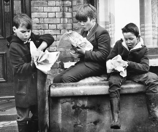Boys eating fish and chips, Balham, SW London