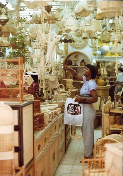 British Caribbean woman points to an item, novelty shop, Hon