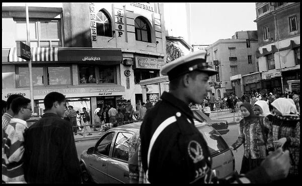 Busy street with policeman Alexandria, Egypt
