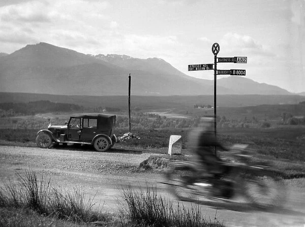 Car and motorbike passing on a road, Scotland