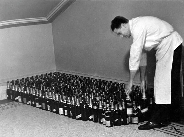 Champagne Hoard. Lining up bottles of champagne in rows in preparation