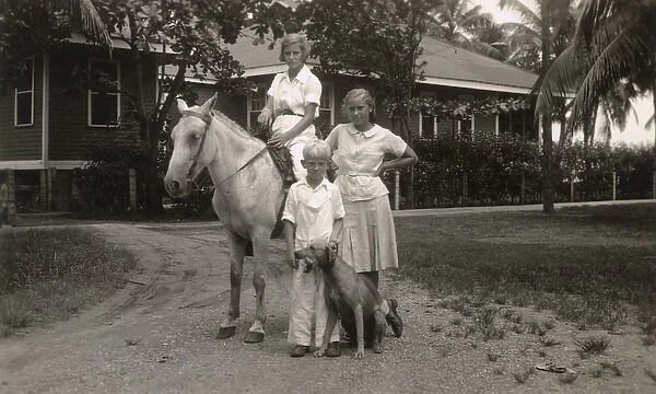 Three children with pony and dog, USA