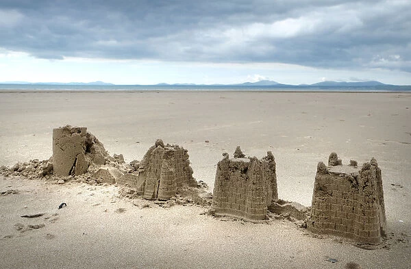 Childs abandoned sandcastles at low water on Harlech beach