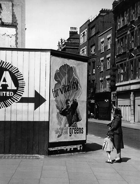 Contemplating a nutritional advice poster in London, 1940s