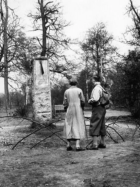 A couple of hikers stop to read the inscription on the sundial monument to daylight