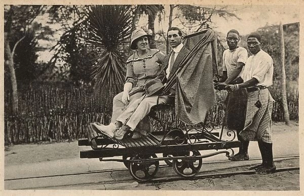 Couple riding trolley, Beira, Mozambique, East Africa