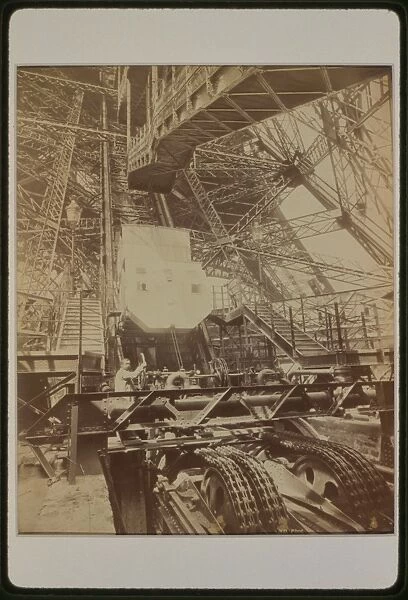 Eiffel Tower machinery with man beside wheel that raises ele