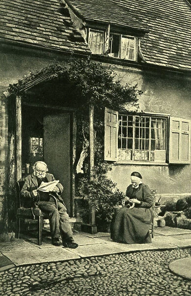 Elderly couple outside cottage, Little Comberton, Worcs