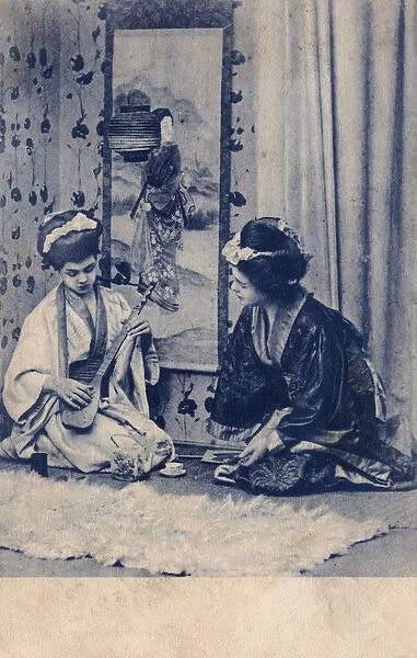Two European girls dressed as Geishas playing music