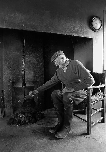 A farmer sits in the farm kitchen, Co Clare, Ireland