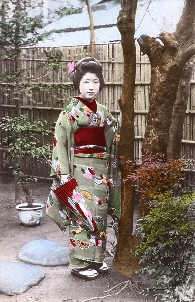 Geisha Girl with patterned kimono and umbrella, Japan