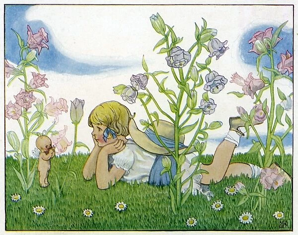 Girl with a baby fairy lying in the garden in summer