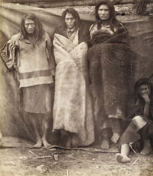 Group of Native Americans, three standing, one seated on the