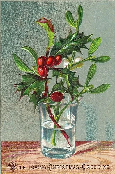 Holly and mistletoe arrangement on a Christmas card
