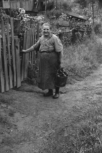 Hungarian miners wife bringing home coal for the stove from
