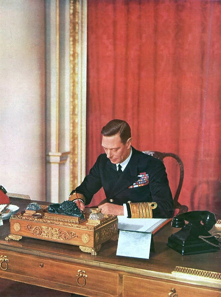 King George VI at his desk in naval uniform, 1942