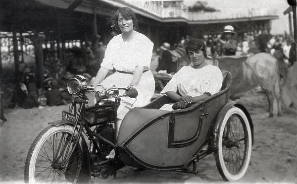 Two ladies on a 1914 Triumph motorcycle & sidecar