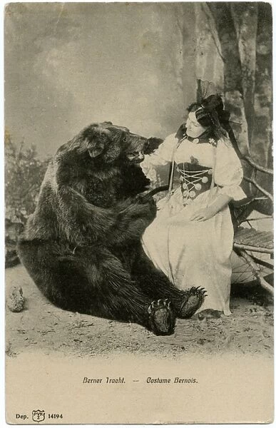 A lady in Traditional Bernaise costume posing with a bear