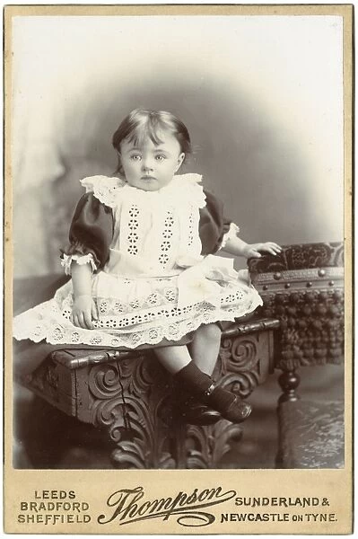 Little Victorian girl in white lacy dress