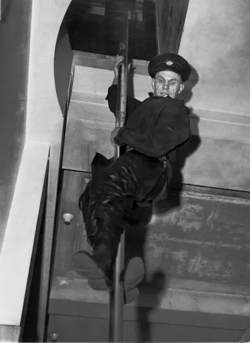 Framed Print : Print of a London Fire Brigade Fireman sliding down a pole