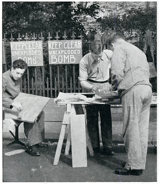 Men painting warning signs for unexploded bombs, Sept 1939