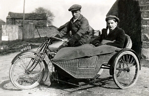 Two men on veteran motorcycle & sidecar