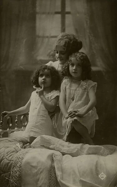 Mother and two little girls at bedtime