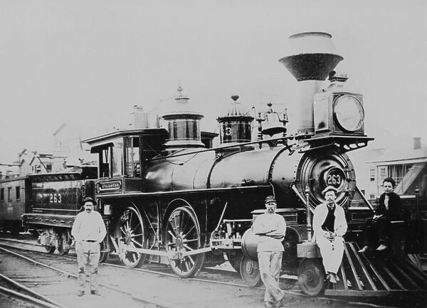 An old fashioned steam train and workers