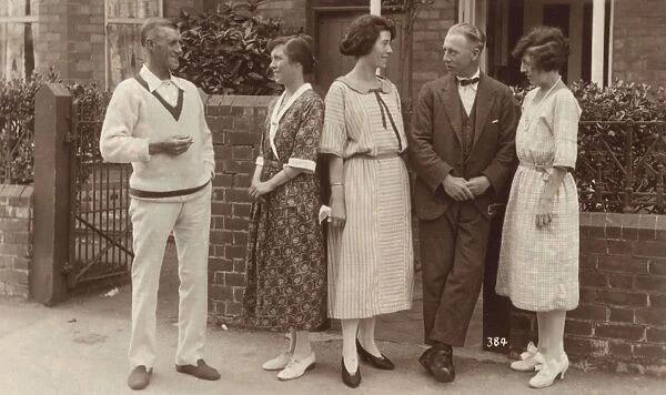 Five people standing outside a house
