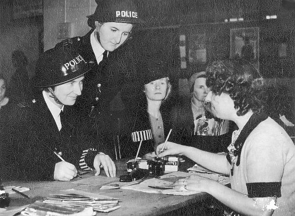 Two policewomen registering for war work