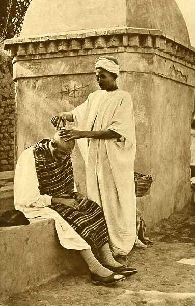Saharan barber and client, Algeria, North Africa