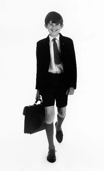 SCHOOLBOY. A schoolboy walks along carrying his satchel. Date: late 1960s