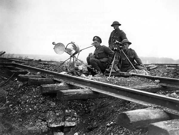 Three soldiers using lamp for signalling, France, WW1