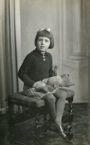 Studio photo of young girl and teddy bear