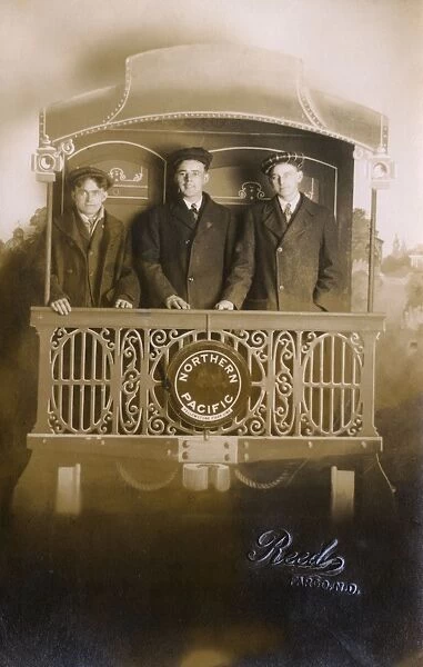 Studio photo, three young men on Northern Pacific train