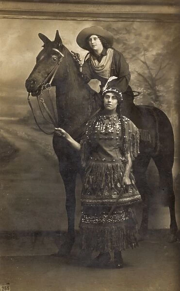 Two women in costume with horse in studio photo