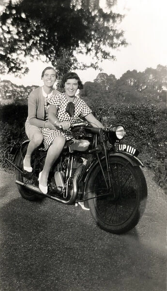 Two women on a veteran motorcycle