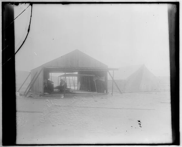 Wright brothers rebuilding their glider in a wooden shed ere
