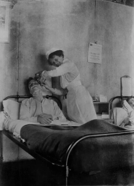 WW1 - Nurse shaving soldier