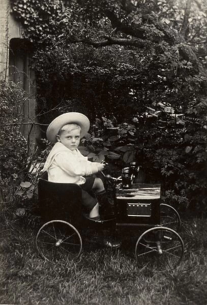Young boy in an elegant toy car