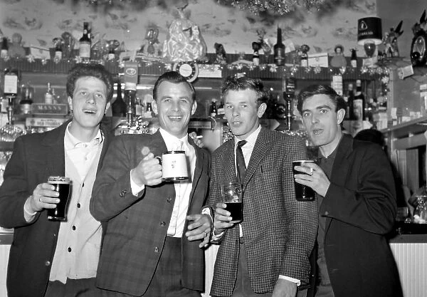 Four young men enjoying a pint of beer, Walton, Essex