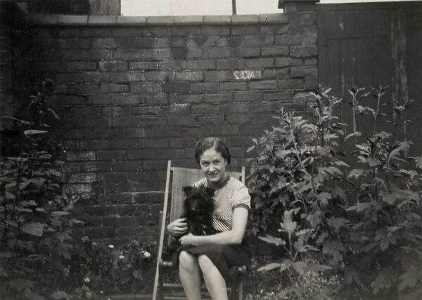 Young woman in deckchair with dog